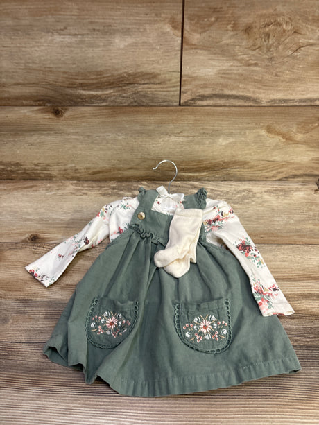 Front view of Cupcakes & Cashmere 3-piece set with floral white shirt, green embroidered skirtall, and cream socks