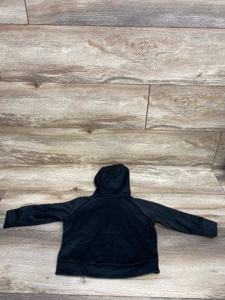 Back view of a black children's hooded sweatshirt laid flat on wooden floor background