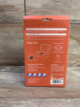 Back of Baby Bell anti-abandonment device box showing product diagram and technical specs on wooden floor