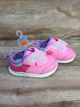 Pink baby sneakers with butterfly wing Velcro, size 4, on wood background