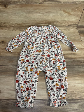 Long sleeve baby floral romper with ruffle cuffs on wood background