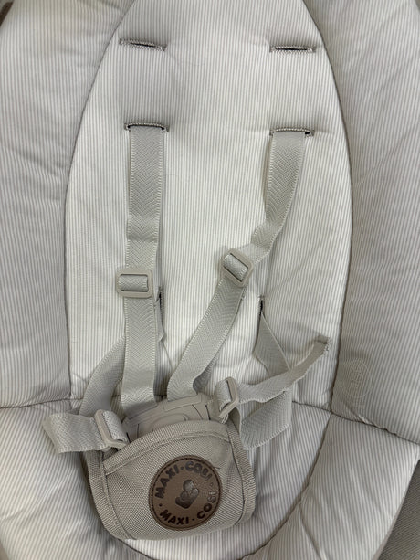 Front close-up of Maxi-Cosi Cassia Baby Swing in Classic Oat showcasing its harness and padded striped seat