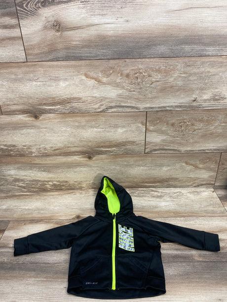 Black Nike kids jacket with neon green zipper and hood lining on wood floor, Dri-Fit fabric