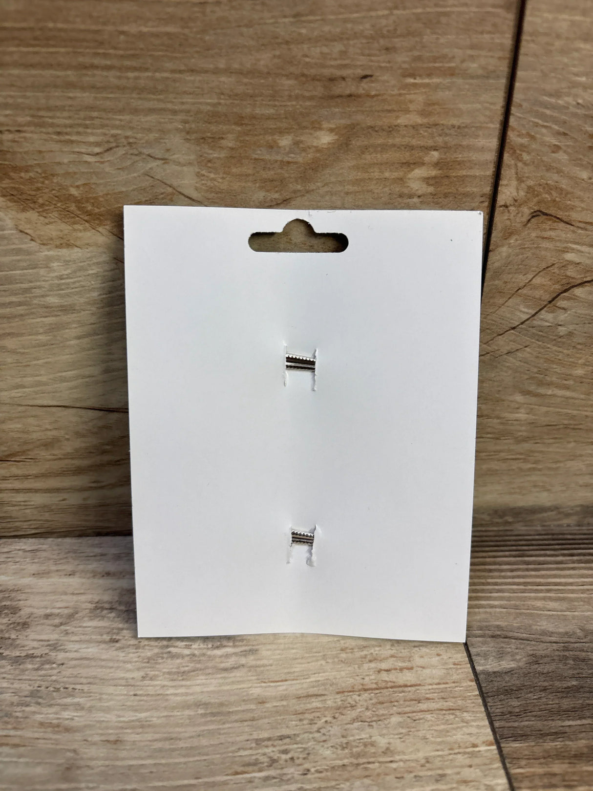Front view of 2-pack mint green hair bows display card showcasing two silver alligator clips on wood background