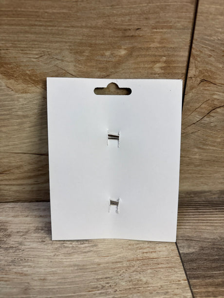 Front view of 2-pack mint green hair bows display card showcasing two silver alligator clips on wood background