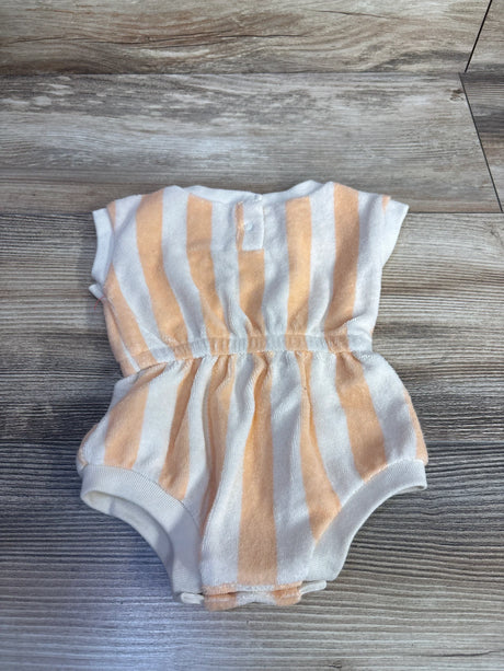 Flat lay of Cat & Jack newborn terry cloth romper with tan and white vertical stripes, elastic waist, and snap crotch on wood background