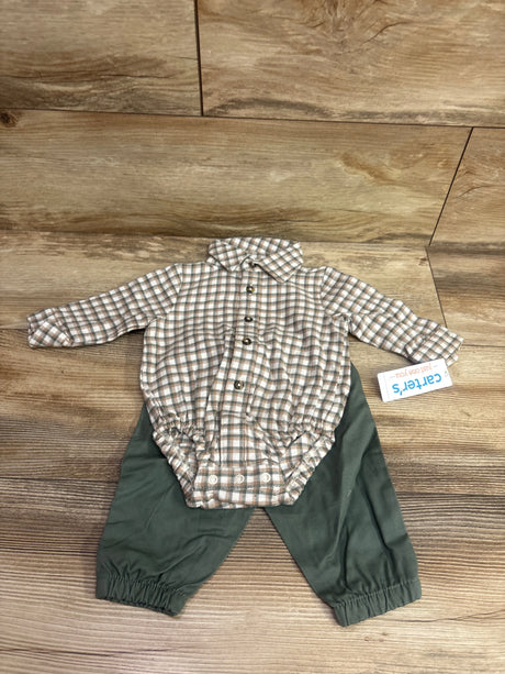 Top-down view of a Just One You romper and pants set showcasing a plaid button-up romper and dark green pants on wood flooring