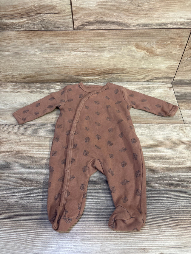 Flat lay of Ecojoy brown kimono-style footed sleeper (3M) showing asymmetrical snap-front closure and leaf print on wood background