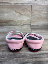 Rear view of pink toddler PU leather sneakers size 3C showing hard black sole with red tread and Velcro strap on wood floor