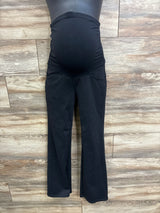 Front view of black Ewedoos maternity over-belly pants showing stretch belly panel and slight flare against wood floor