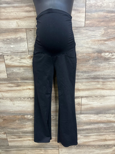 Front view of black Ewedoos maternity over-belly pants showing stretch belly panel and slight flare against wood floor
