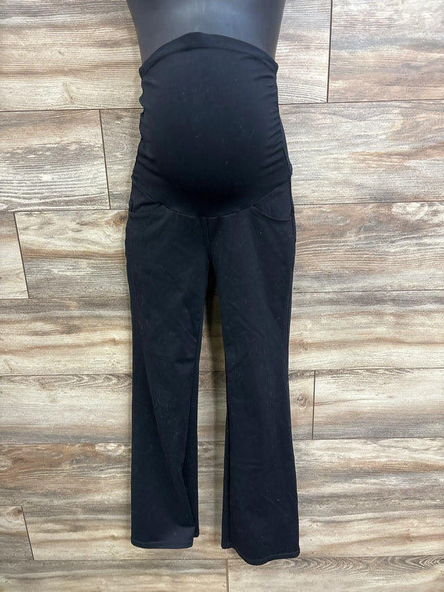 Front view of black Ewedoos maternity over-belly pants showing stretch belly panel and slight flare against wood floor