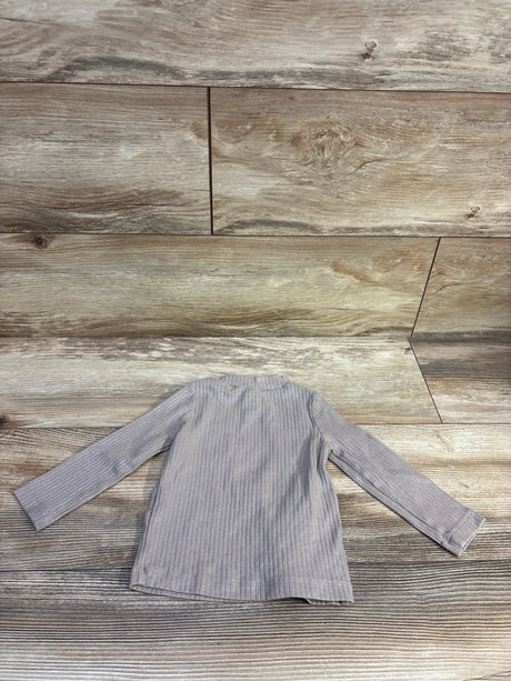 Oshkosh long sleeve ribbed metallic tan shirt for infants size 12m on a wooden background