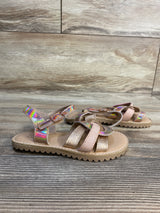 Girls’ iridescent strappy sandals with glitter and buckle on wooden floor