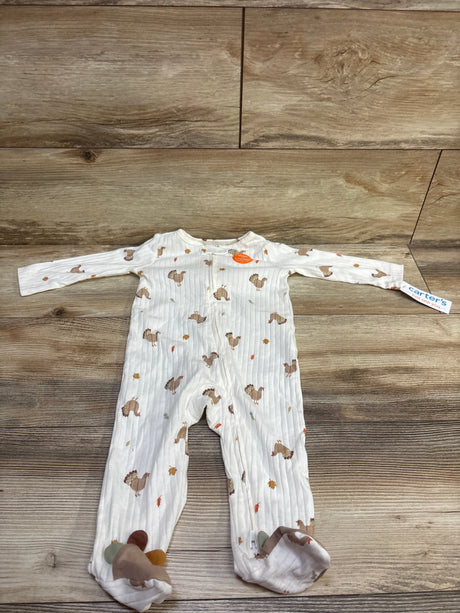 Front view of Just One You ribbed turkey sleeper showcasing white fabric, long sleeves, footed legs, and turkey print on wood flooring