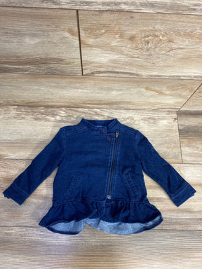 Navy blue toddler jacket with ruffle hem, front zipper, and button details on wood floor