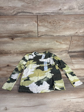 Kids long sleeve camo shirt with green, white, and yellow pattern on wood background