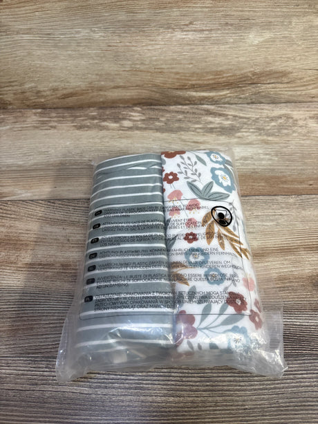 Front view of Momcozy 2-pack swaddle blankets showing gray stripes and floral print in clear packaging on light wood