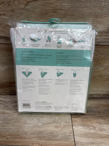 Back view of Ideal Baby 3pk muslin swaddle blankets showing 42 by 42 inch size and swaddling instructions in clear packaging