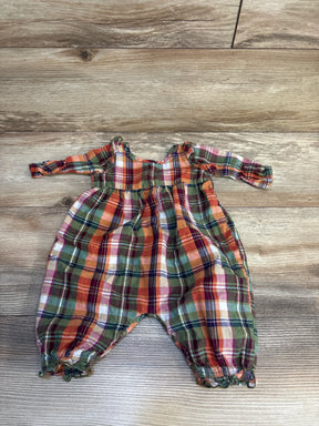 Plaid long sleeve baby romper with green, orange, and red checkered pattern on wood floor