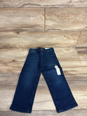 Dark wash kids' jeans with tags, laid flat on wood floor, children's clothing resale.