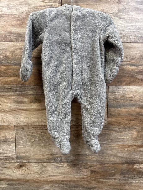 Front view of a grey Sherpa Magnetic Pram showcasing footed legs and long sleeves on a wood plank background