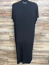 Black maternity dress with short sleeves, displayed on mannequin against wood panel background