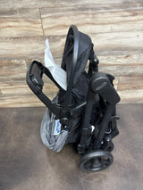 Folded black Graco stroller with foam padding, compact and ready for storage or transport