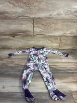 Flat lay of Burt's Bees Baby purple floral footed sleeper (18m) showing diagonal zipper and grippy soles on wood floor