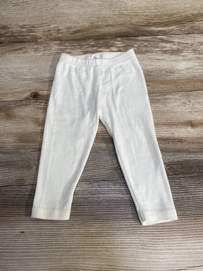 Flat lay of Viverano organic pointelle baby leggings, white, 3 to 6 months, showing knit texture on light wood background