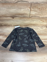 Long sleeve kids dinosaur print shirt on wooden background