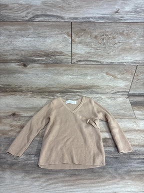 Top-down view of H&M tan fine-knit wrap-front cardigan 3-4T showing ribbed texture and side tie on wood floor