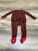 Flat lay of Posh P buffalo-check ruffle footie showing back ruffle detail and built-in red footies on wood background