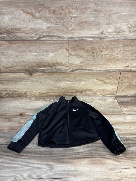 Black kids' zip-up Nike jacket with aqua sleeve accents, displayed on wooden floor.