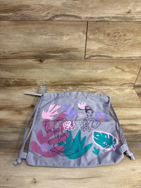 Drawstring backpack with colorful Princess and mermaid illustrations on light purple fabric on wooden floor