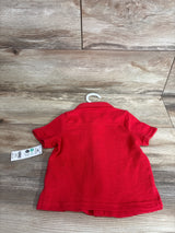 Back view of red OshKosh short-sleeve button-up baby shirt (12M) showing collar, knit texture, and tag on wood background