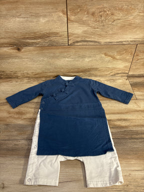 Blue toddler kimono-style romper with white pants on wooden floor