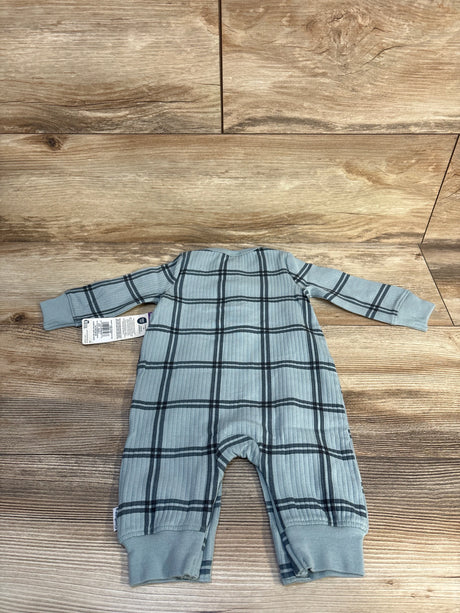 Blue plaid long sleeve baby romper with ribbed fabric on wooden background