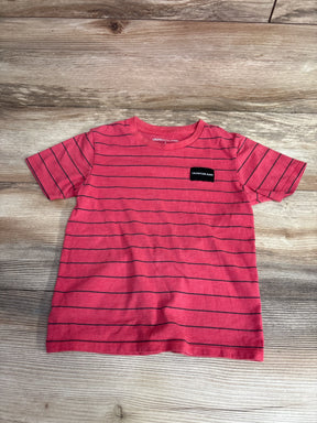 Flat lay of red Calvin Klein short sleeve toddler t-shirt size 5T showing thin black horizontal stripes and small chest logo on wood background