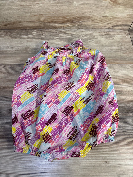Flat lay of sleeveless bubble romper in pink print with ruffled elastic neckline, elastic legs, and three snap closures