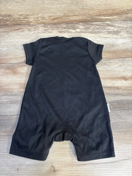 Black short sleeve baby romper laid flat on wooden surface, gently used kids clothing