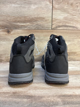 Back view of black and gray children's hiking boots on wood floor