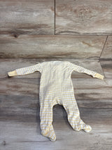 Flat-lay of Member's Mark striped footed sleeper, pale orange and white, showing long sleeves with fold-over mittens and enclosed feet on wood floor