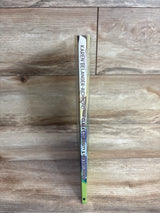 Spine of a children's book titled Clara's Curiosity & Her Foxy Friends by Karen Belanger-Richmond on wooden surface