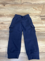 Navy blue kids cargo joggers with drawstring waist, laid flat on wood floor