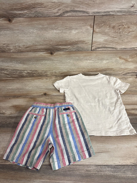 Top-down view of cream slub tee (back) and linen striped shorts showing elastic waist and back pockets on wood floor