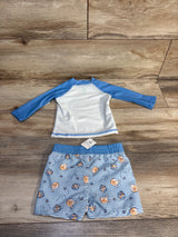 Blue and white baby swim set with Winnie the Pooh print, size 6M, laid on wood floor