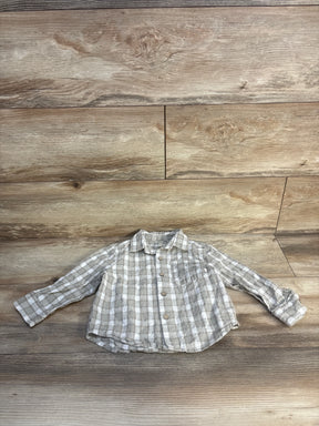 Light gray plaid long sleeve button-up toddler shirt on wood background