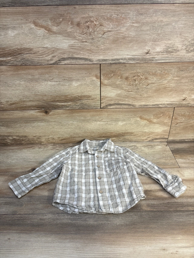 Light gray plaid long sleeve button-up toddler shirt on wood background