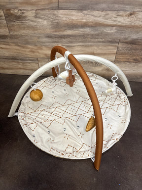 White baby play mat with brown geometric pattern and hanging plush toys, ideal for infant tummy time and sensory play.
